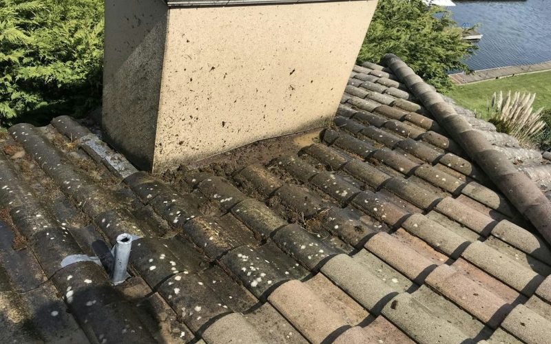 the roof of a house with a pipe sticking out of it